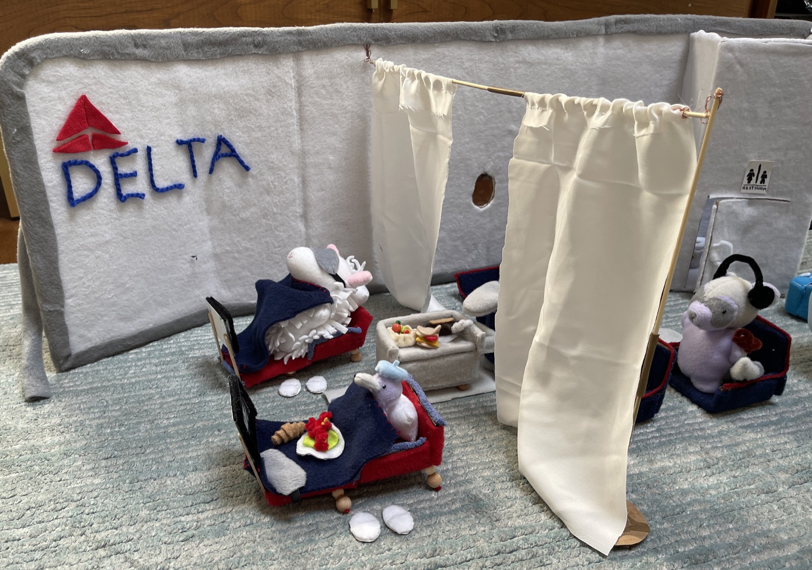 Avery's handmade characters relaxing in a miniature airplane cabin